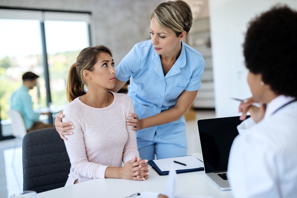 A mother and daughter speaking with a healthcare professional